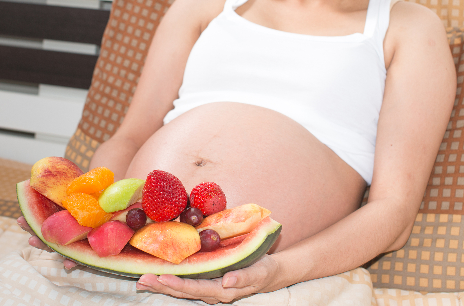 Portrait of asian pregnant women with fresh tasty sweet fruits decoration