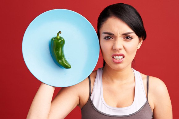 woman-holding-a-plate-with-green-pepper