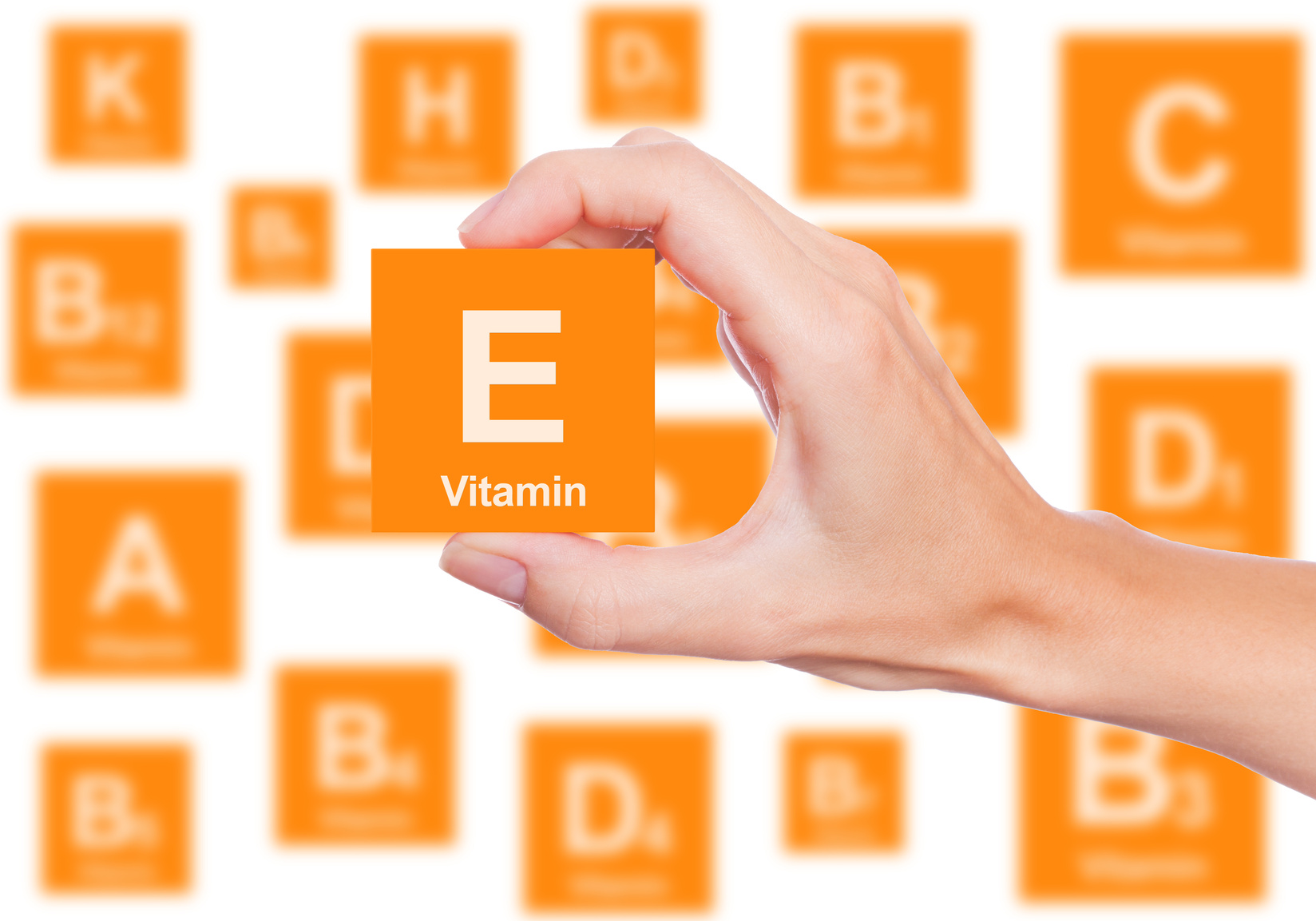 Hand holds a box of vitamin E